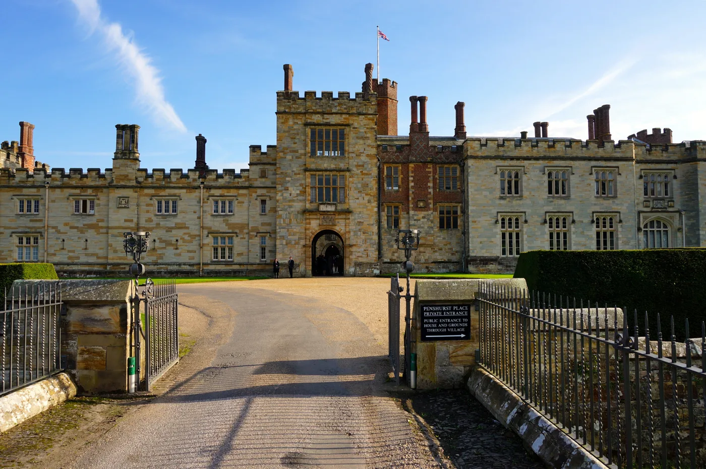 The front of Penshurst Place seen from its private gate. The sign directs visitors to the public entrance through the village.